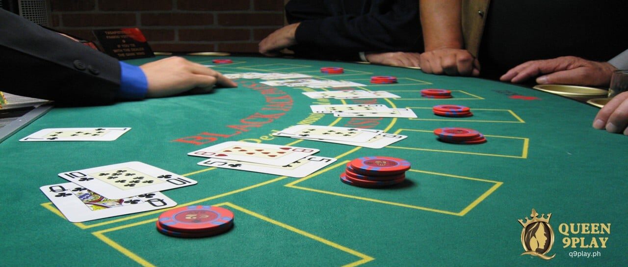 a blackjack table with cards and casino chips